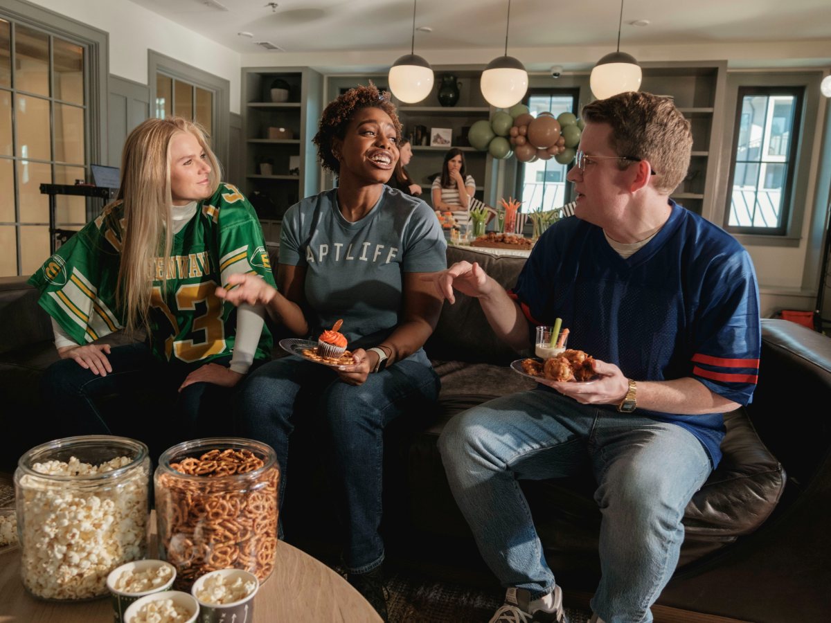 Friends watching a live sports broadcast on FalconIPTV